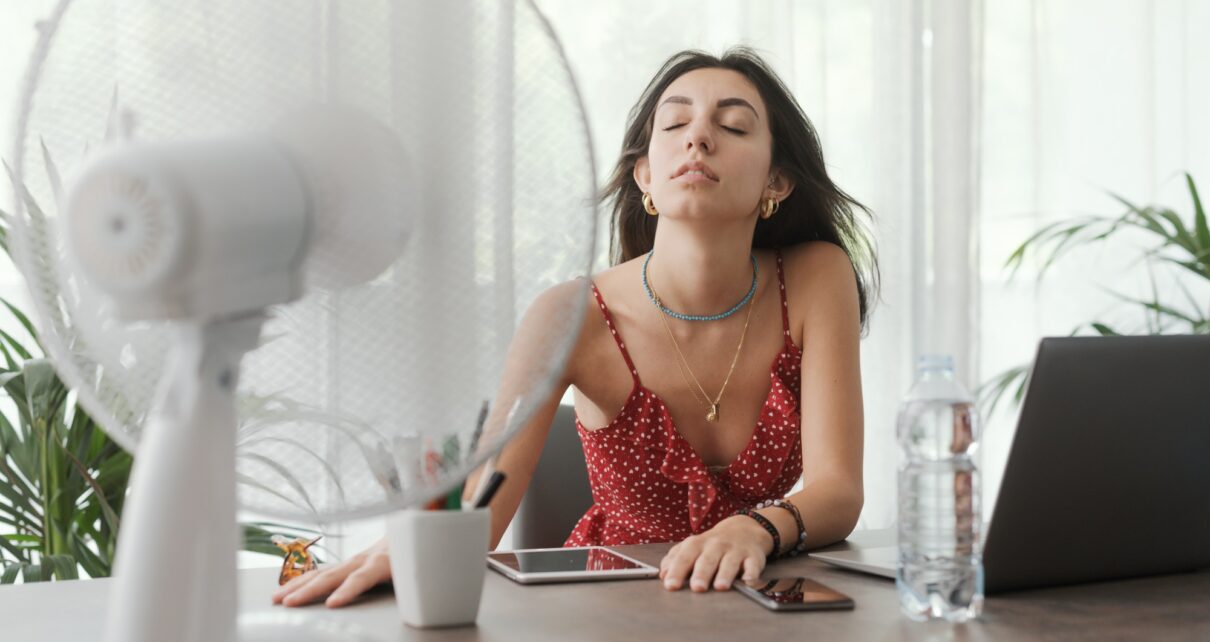 Woman cooling herself at home
