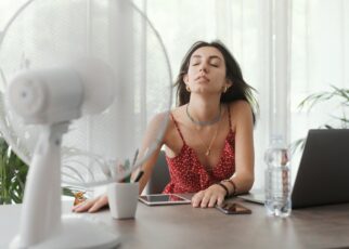 Woman cooling herself at home