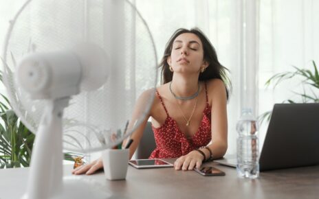 Woman cooling herself at home